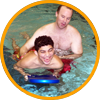 image of special recreation professional swimming with disabled teen